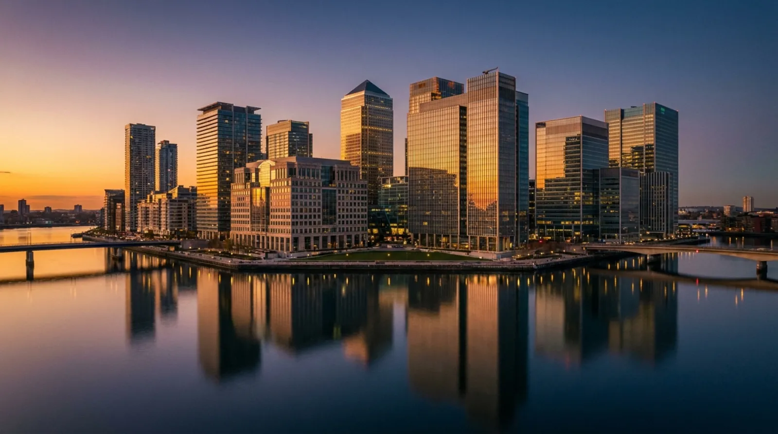 Modern financial-district towers on a waterfront island at dusk, representing a free-zone jurisdiction