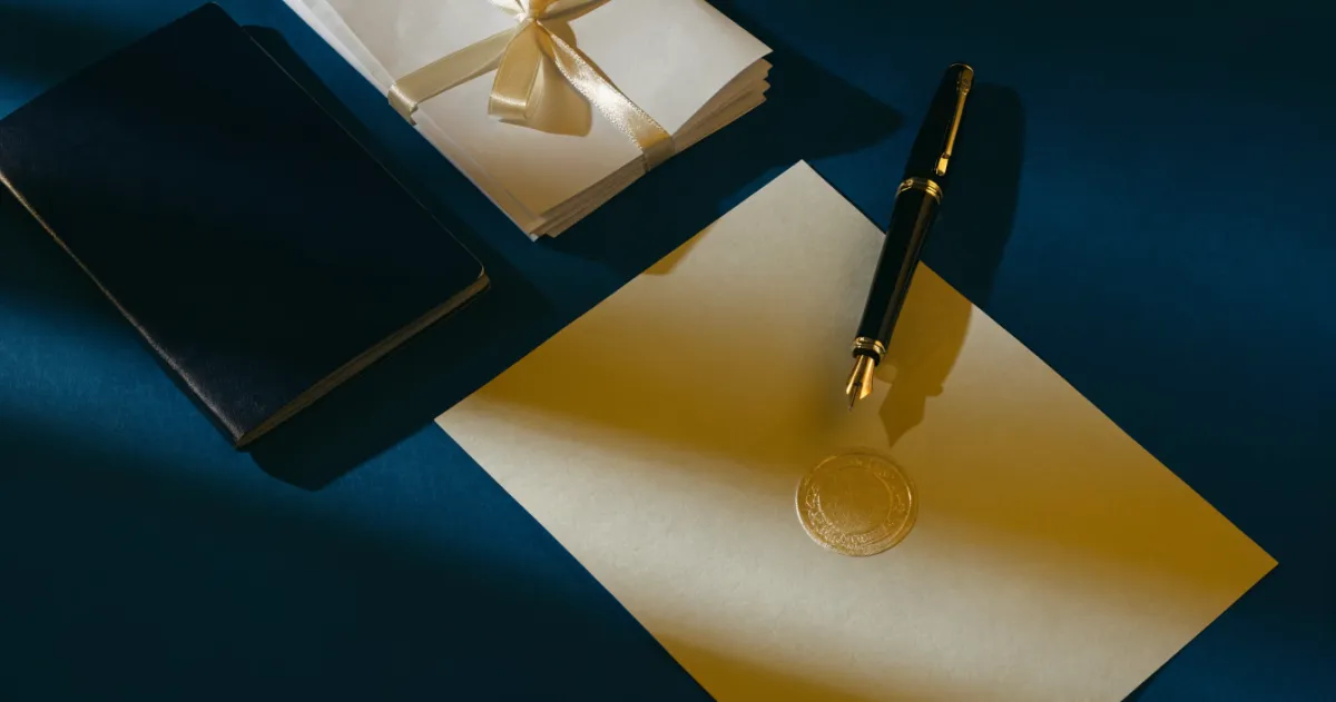 Notarised affidavit document with seal, pen and passport arranged on a deep blue desk