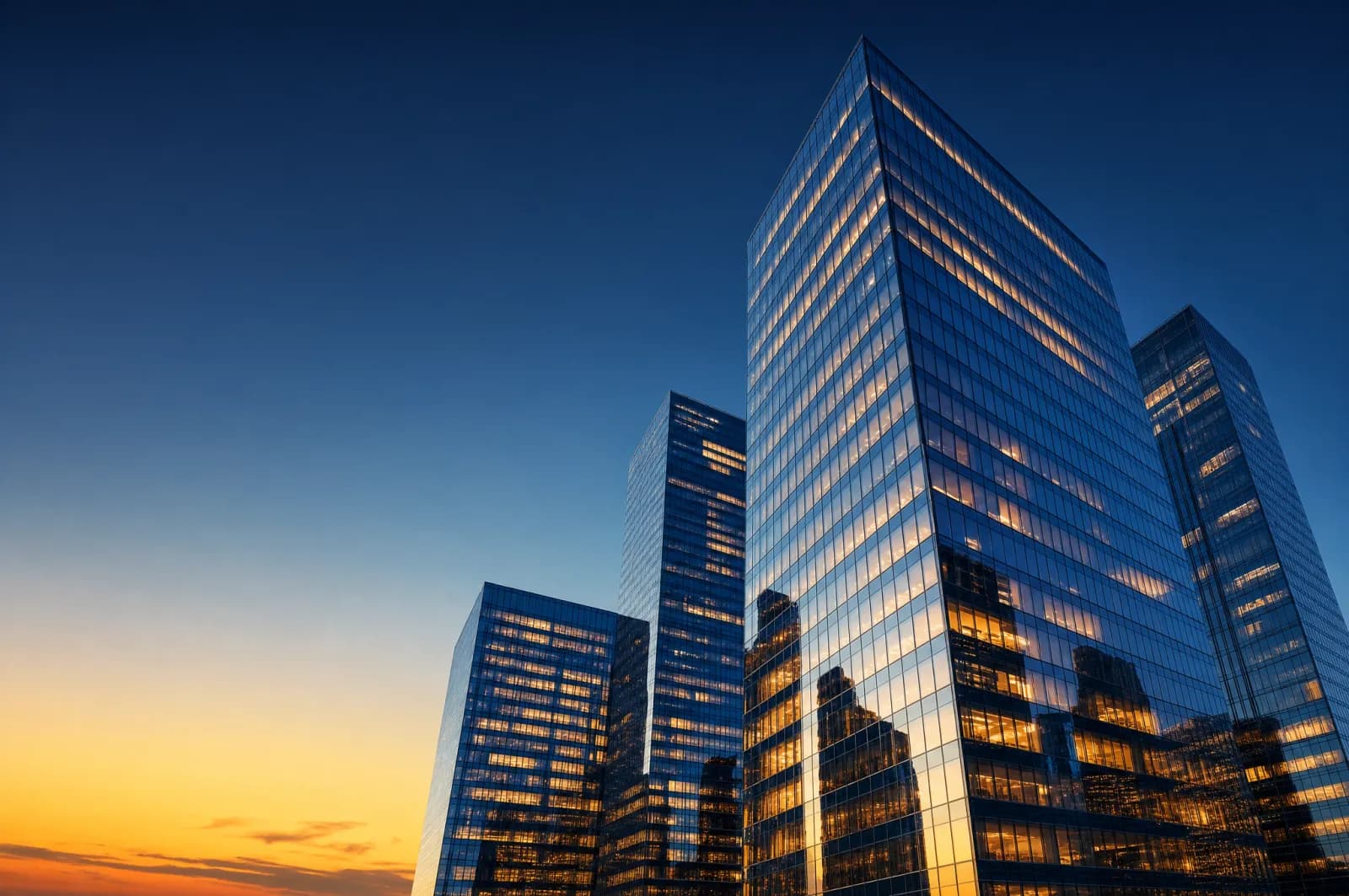 Modern glass office towers in a UAE business district at dusk symbolising public joint stock companies and other corporate structures