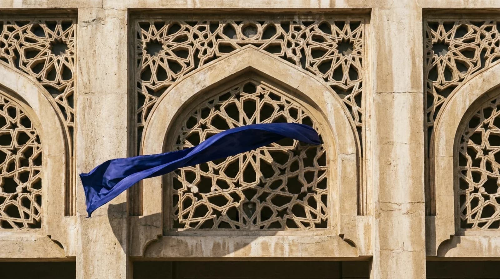 Sharjah courthouse facade detail with ornamental stone latticework — Sharjah labour court procedure 2026